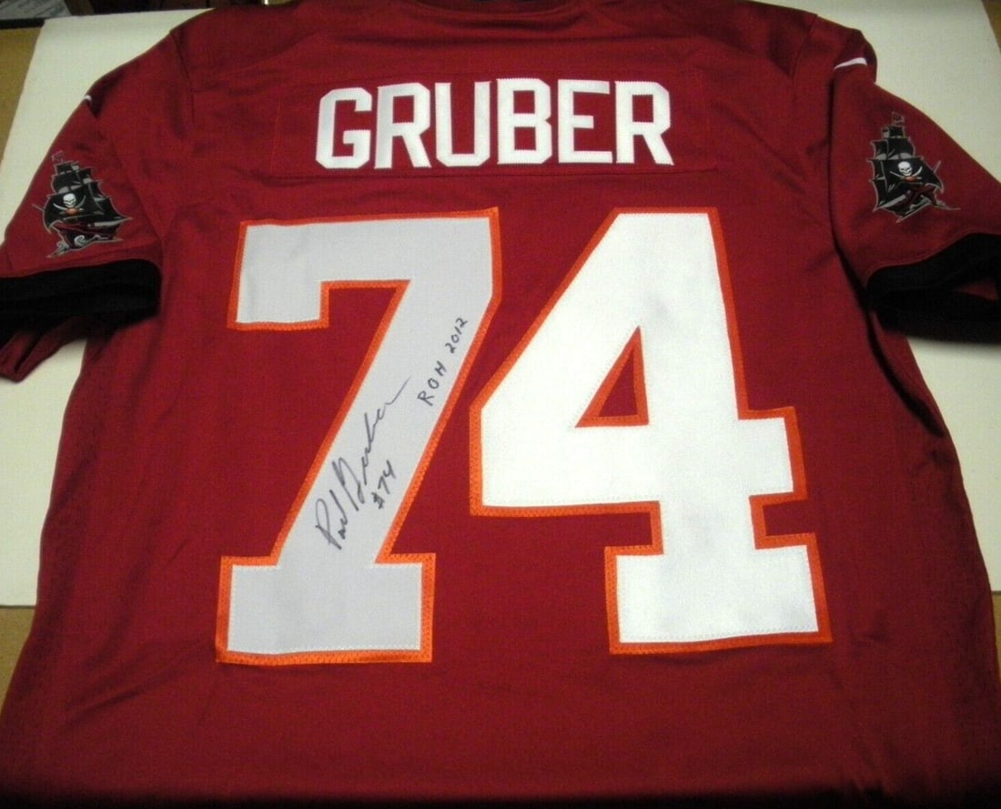 Paul Gruber Signed Tampa Bay Buccaneers Nike Jersey with COA: Paul Gruber Signed Tampa Bay Buccaneers Nike Jersey with COA This official licensed Nike jersey features the signature of Paul Gruber, a former player for the Tampa Bay Buccaneers. It is an authentic