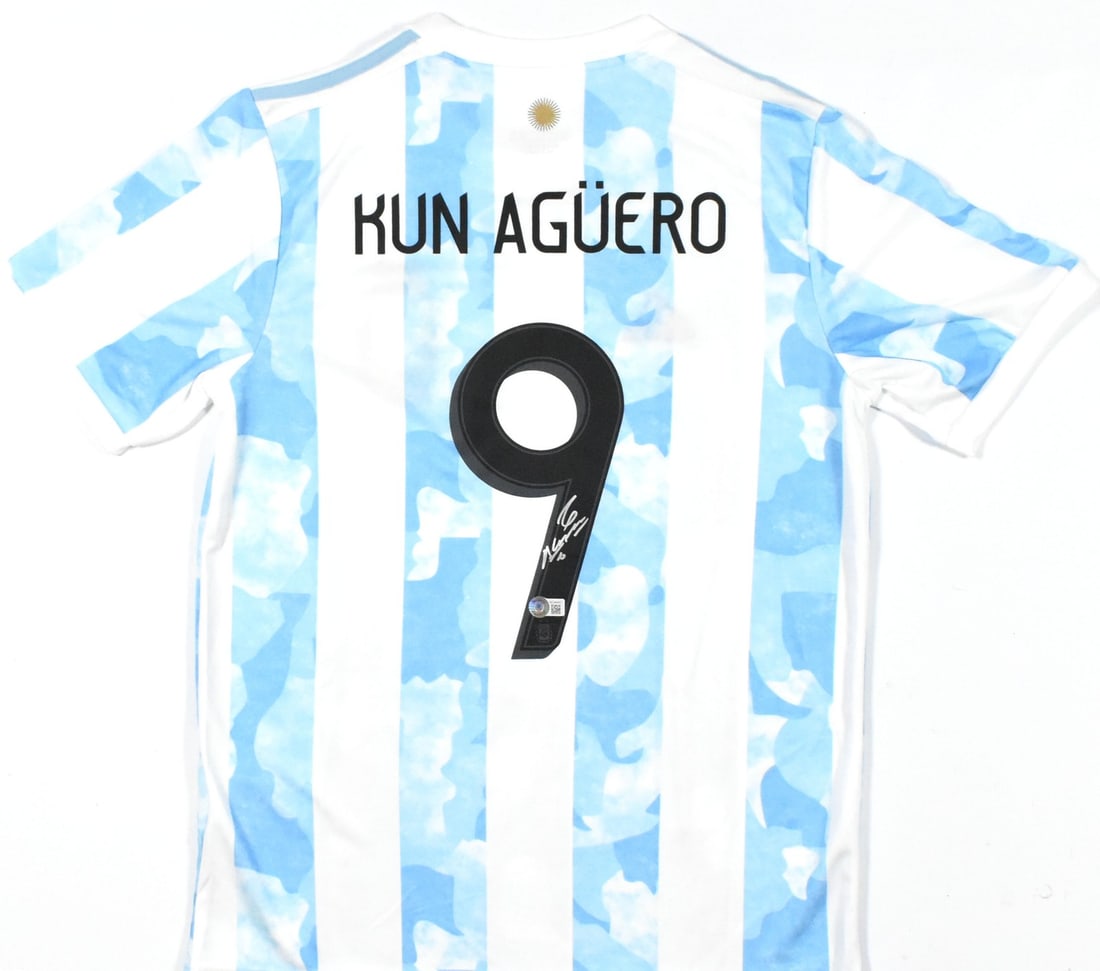 Sergio Aguero Signed Argentina Jersey #9 with Beckett Hologram: Sergio Aguero Signed Argentina Jersey #9 with Beckett Hologram Celebrate the legacy of Sergio Aguero with this signed Argentina FC soccer jersey. This original white jersey features Aguero's iconic #9