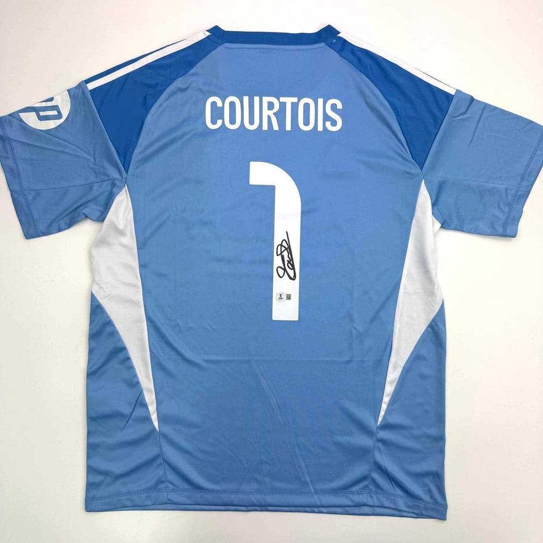 Thibaut Courtois Signed Real Madrid Blue Jersey Beckett COA: Thibaut Courtois Signed Real Madrid Blue Jersey Beckett COA This is an authentic autographed blue jersey of Thibaut Courtois, the renowned Real Madrid goalkeeper. The jersey has been graded and comes