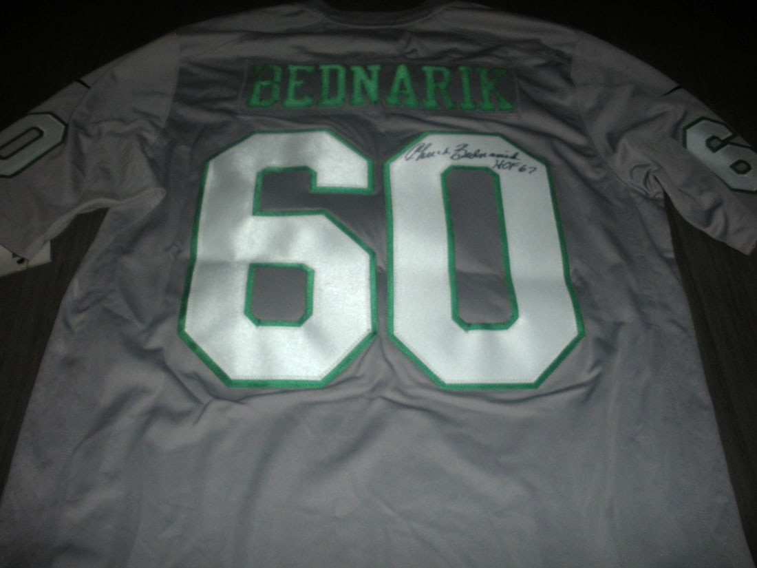 Chuck Bednarik Philadelphia Eagles Signed Nike Jersey with COA: Chuck Bednarik Philadelphia Eagles Signed Nike Jersey with COA This officially licensed Nike jersey is signed by Chuck Bednarik, a legendary figure in Philadelphia Eagles history. The jersey is an ori