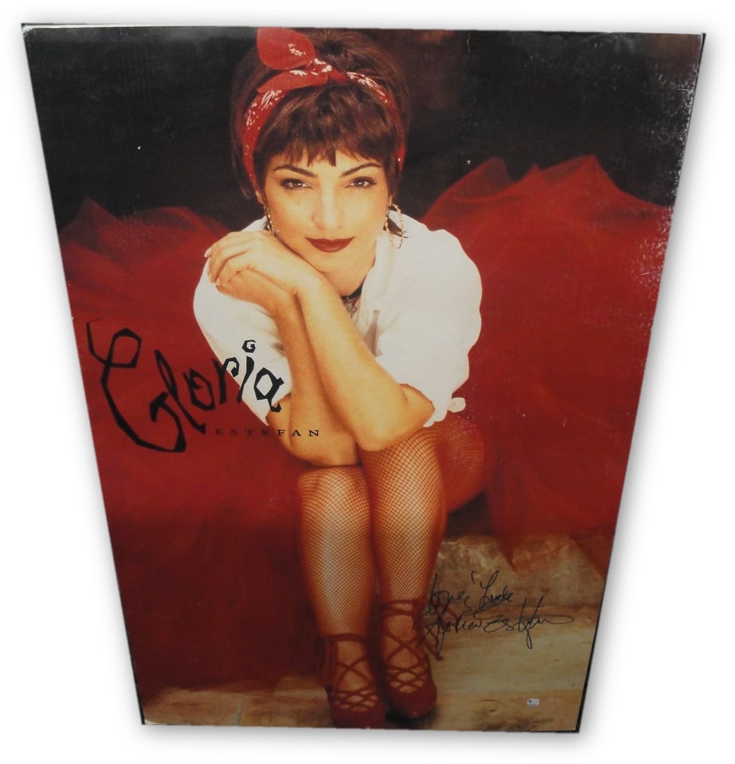 Gloria Estefan Signed 23x35 Matted Poster Authenticated by Global Authentics: Gloria Estefan Signed 23x35 Matted Poster Authenticated by Global Authentics This is an authentic hand-signed autographed poster of Gloria Estefan, measuring 23" x 35". The poster is custom matted and