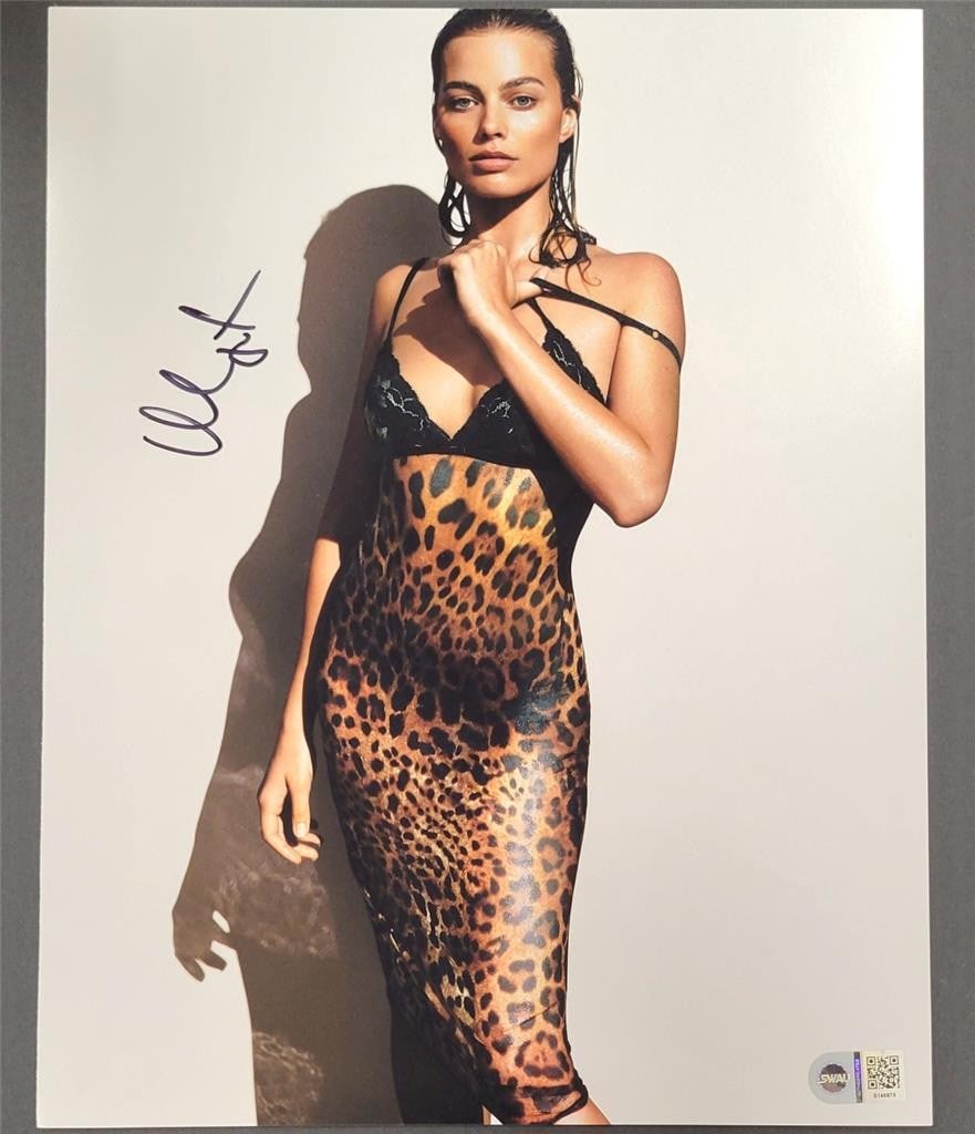 Margot Robbie Autographed 11x14 Photo with SWAU Hologram: Margot Robbie Autographed 11x14 Photo with SWAU Hologram Enhance your collection with this authentic 11x14 photograph signed by Margot Robbie. This original piece features her signature and comes with