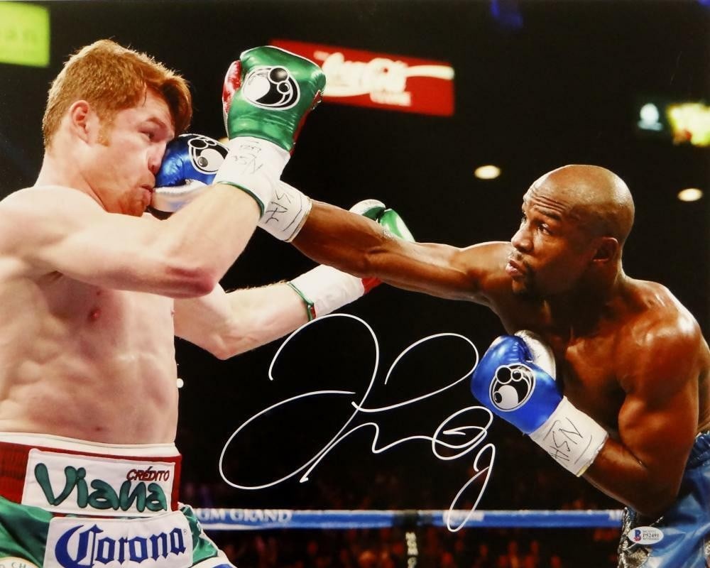 Floyd Mayweather Signed 16x20 Photo vs Canelo Alvarez Beckett Authenticated: Floyd Mayweather Signed 16x20 Photo vs Canelo Alvarez Beckett Authenticated This remarkable 16x20 photo features a thrilling moment from the boxing match between Floyd Mayweather and Canelo Alvarez. T