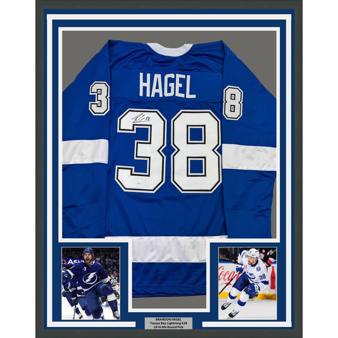 Framed Autographed Brandon Hagel Jersey Tampa Bay Lightning JSA COA 35x39: Framed Autographed Brandon Hagel Jersey Tampa Bay Lightning JSA COA 35x39 This professionally framed and matted display features an autographed blue jersey of NHL player Brandon Hagel, representing th