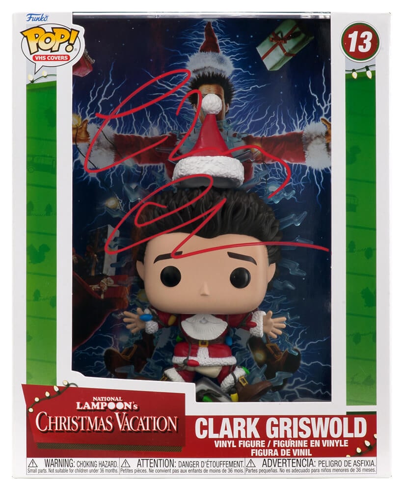 Chevy Chase Signed Christmas Vacation Funko Pop Doll #13 with COA: Chevy Chase Signed Christmas Vacation Funko Pop Doll #13 with COA Celebrate the holiday spirit with this unique Chevy Chase signed Christmas Vacation Clark Griswold VHS cover Funko Pop doll #13. Featu