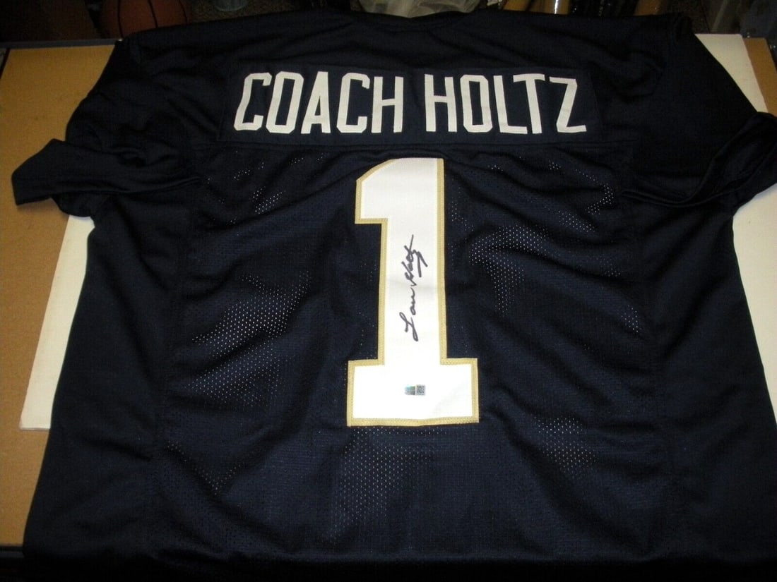 Lou Holtz Signed Notre Dame Fighting Irish Jersey with Steiner COA: Lou Holtz Signed Notre Dame Fighting Irish Jersey with Steiner COA This authentic Notre Dame Fighting Irish jersey, signed by the legendary coach Lou Holtz, is a must-have for any football fan. It fea