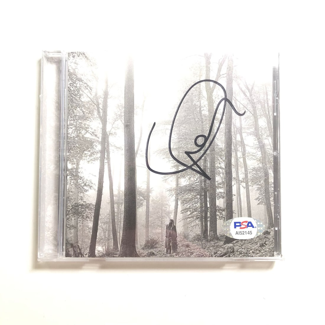 Taylor Swift Folklore Signed CD Cover Authenticated by PSA/DNA: Taylor Swift Folklore Signed CD Cover Authenticated by PSA/DNA This listing features a CD album cover of Taylor Swift's "Folklore," autographed by the artist herself. The signature has been authentica