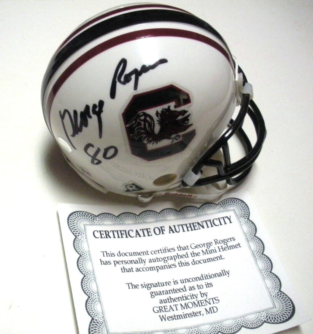 George Rogers Signed South Carolina Gamecocks Mini Helmet with COA: George Rogers Signed South Carolina Gamecocks Mini Helmet with COA This collectible mini helmet features the signature of George Rogers, a legendary player for the South Carolina Gamecocks and Heisman