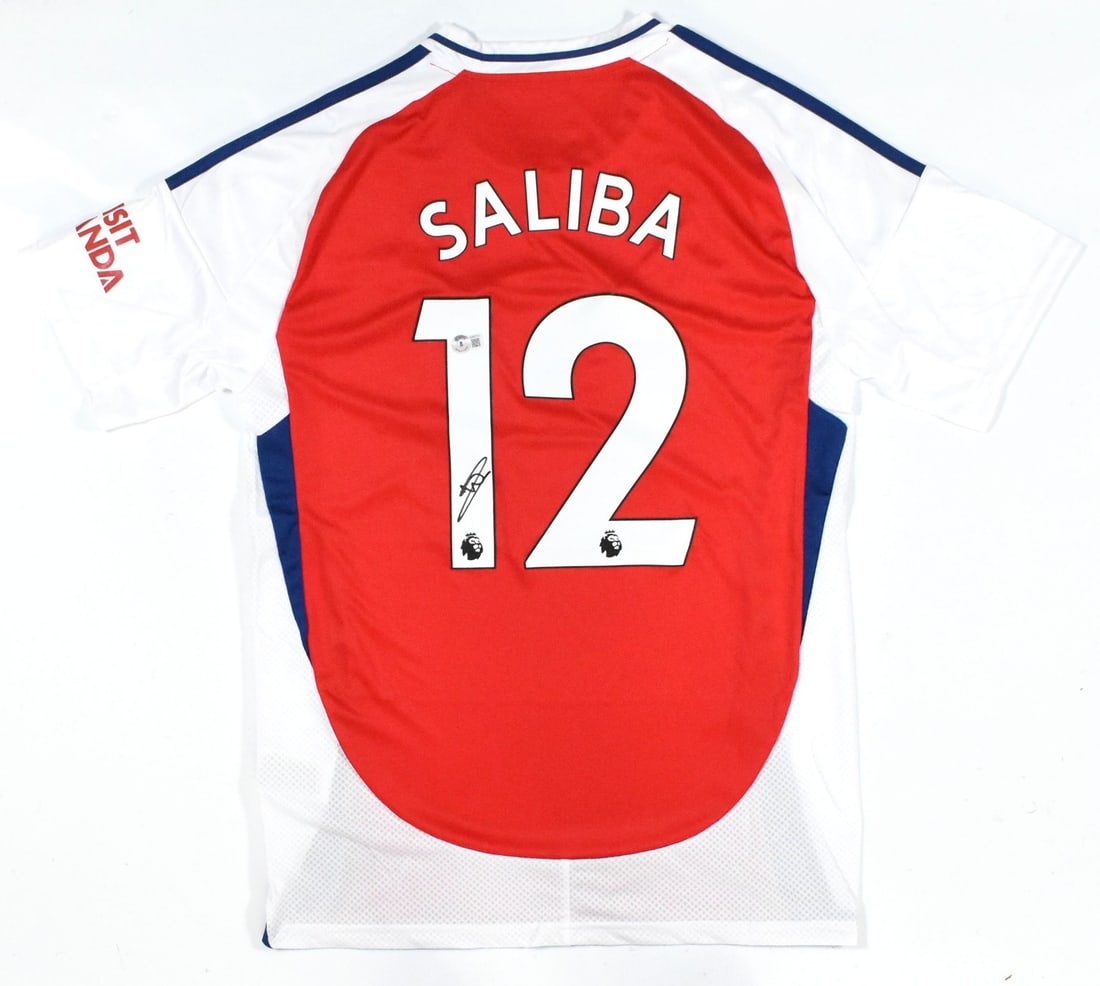 William Saliba Signed Arsenal Home Jersey #12 with Beckett Hologram: William Saliba Signed Arsenal Home Jersey #12 with Beckett Hologram This is an original autographed Arsenal home soccer jersey featuring the signature of player William Saliba, who wears the number 12