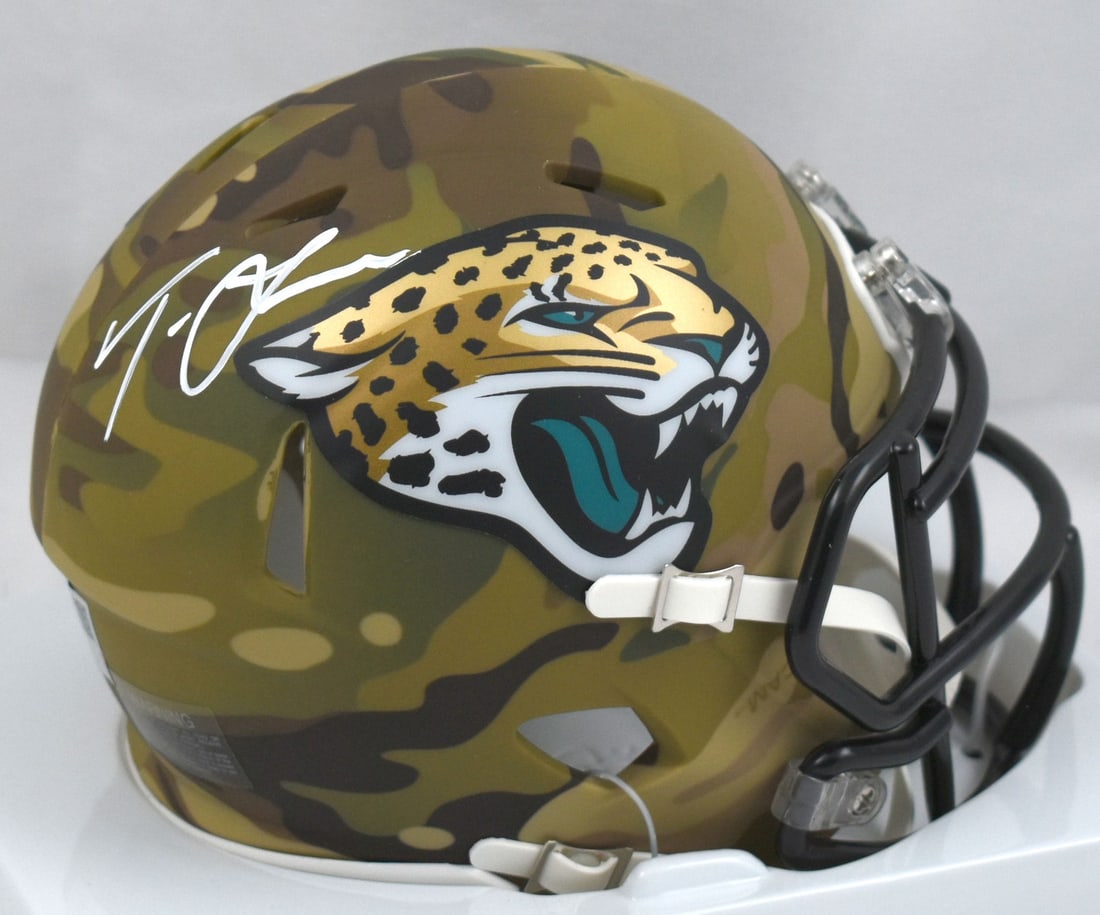 Trevor Lawrence Signed Jacksonville Jaguars Camo Mini Helmet Certified by Fanatics: Trevor Lawrence Signed Jacksonville Jaguars Camo Mini Helmet Certified by Fanatics This is a Jacksonville Jaguars mini helmet featuring the autograph of quarterback Trevor Lawrence. The helmet is desi