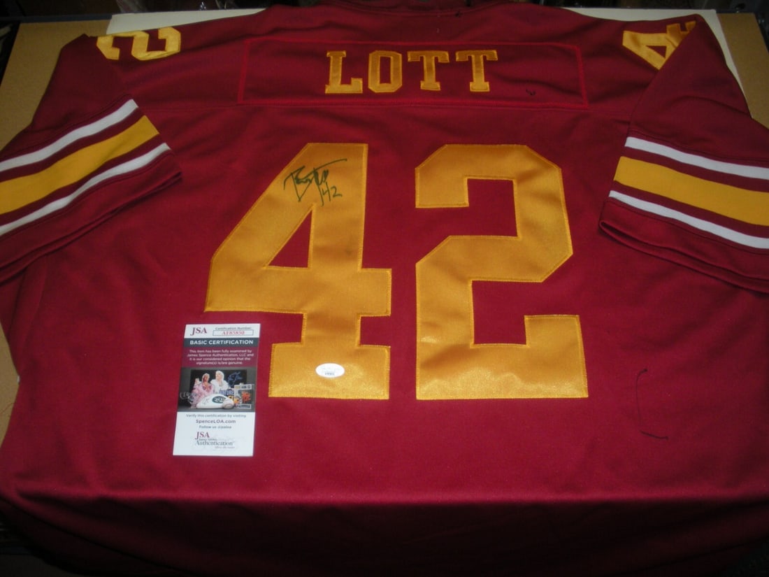 Ronnie Lott USC Trojans Signed Jersey with JSA COA: Ronnie Lott USC Trojans Signed Jersey with JSA COA This officially licensed USC Trojans jersey features the signature of football legend Ronnie Lott. A must-have for any dedicated fan, this jersey is