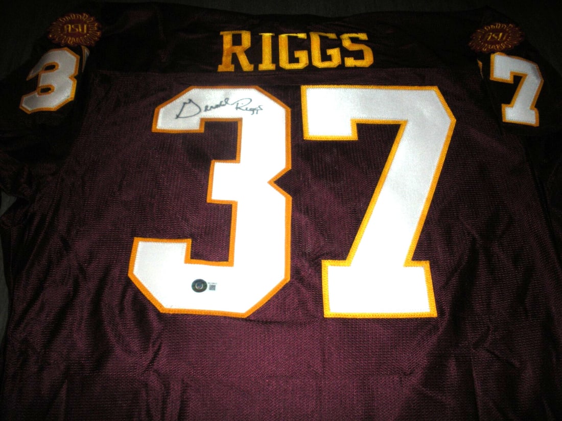 Gerald Riggs Signed Arizona State Rawlings Jersey with COA: Gerald Riggs Signed Arizona State Rawlings Jersey with COA This officially licensed Rawlings jersey features the signature of Gerald Riggs, a prominent figure in NFL football. The jersey is classified