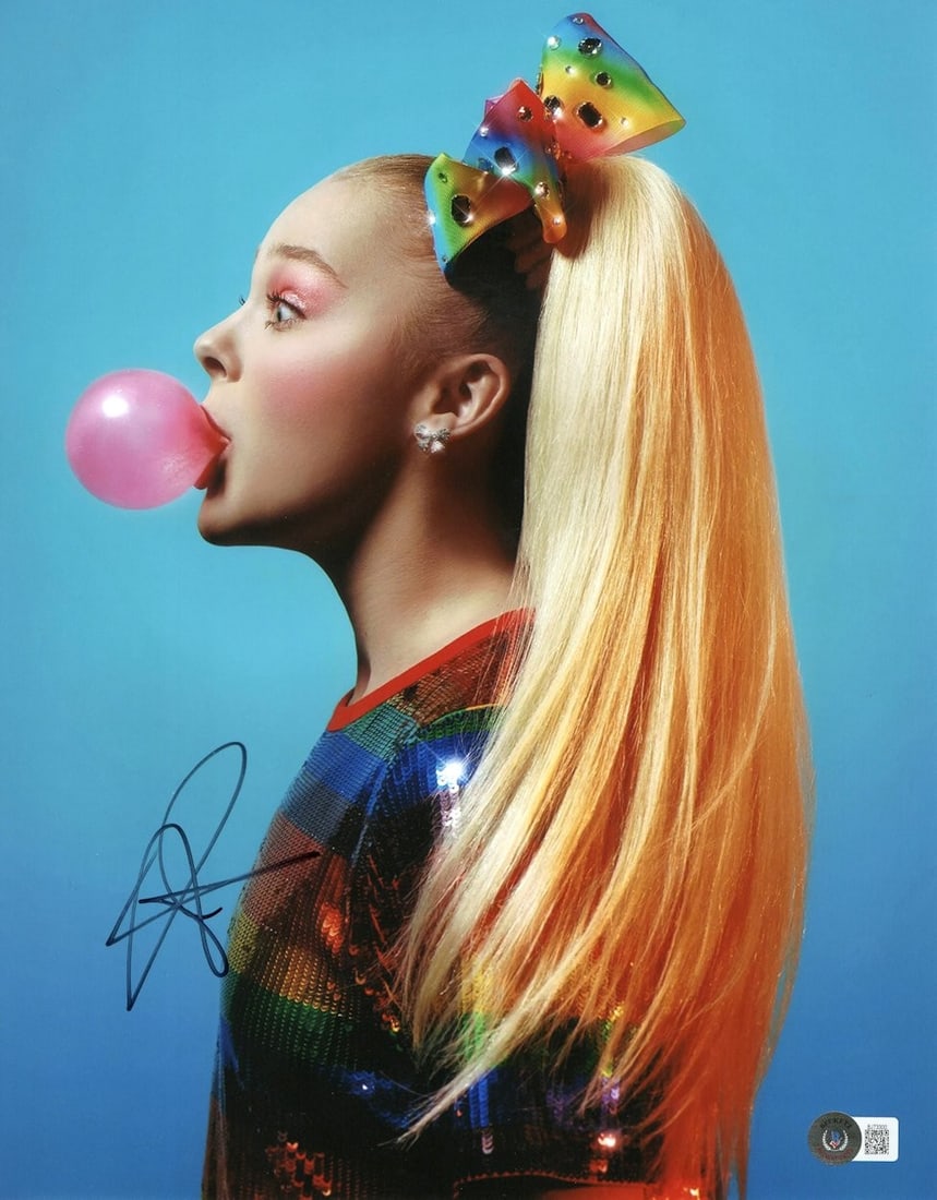 JoJo Siwa Autographed 11X14 Photograph Blowing Bubble Gum Beckett Authenticated: JoJo Siwa Autographed 11X14 Photograph Blowing Bubble Gum Beckett Authenticated Capture a moment of fun with this authentic JoJo Siwa signed 11X14 photograph, featuring her blowing bubble gum. This vi