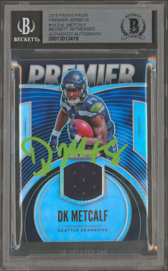 DK Metcalf Signed 2019 Panini Prizm Premier RC Auto 10 BAS: DK Metcalf Signed 2019 Panini Prizm Premier RC Auto 10 BAS Celebrate your collection with this autographed 2019 Panini Prizm Premier Jerseys #19 Rookie Card, personally signed by DK Metcalf of the Sea