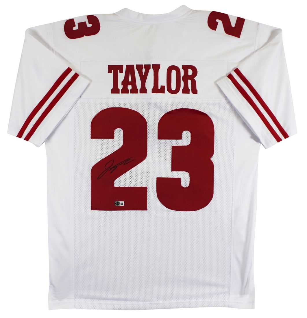Jonathan Taylor Signed Wisconsin Badgers White Jersey with Beckett Authentication: Jonathan Taylor Signed Wisconsin Badgers White Jersey with Beckett Authentication This white pro style jersey is personally signed by Jonathan Taylor of the Wisconsin Badgers. The jersey is custom-sti