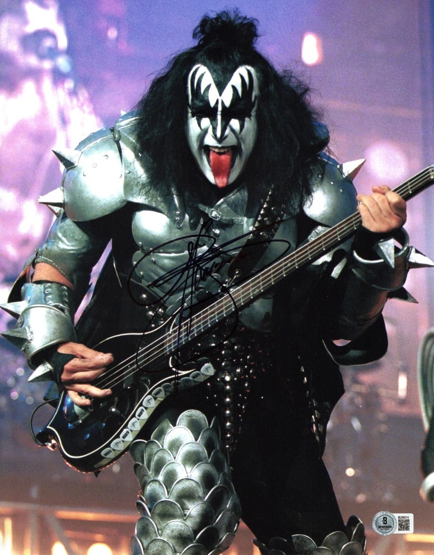 Gene Simmons Signed 11x14 KISS Photo Beckett Authenticated: Gene Simmons Signed 11x14 KISS Photo Beckett Authenticated Capture a piece of rock history with this Gene Simmons autographed 11x14 photograph featuring the iconic KISS frontman on stage, tongue out.