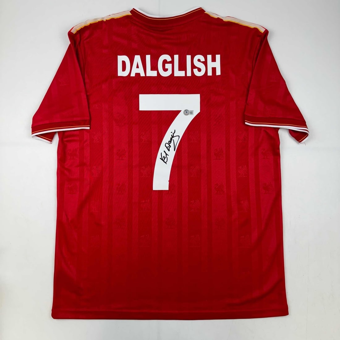 Kenny Dalglish Signed Liverpool Jersey with BAS COA: Kenny Dalglish Signed Liverpool Jersey with BAS COA This original autographed Kenny Dalglish Liverpool Red Crown Paints Jersey is a must-have collectible for fans of the Premier League legend. Authent