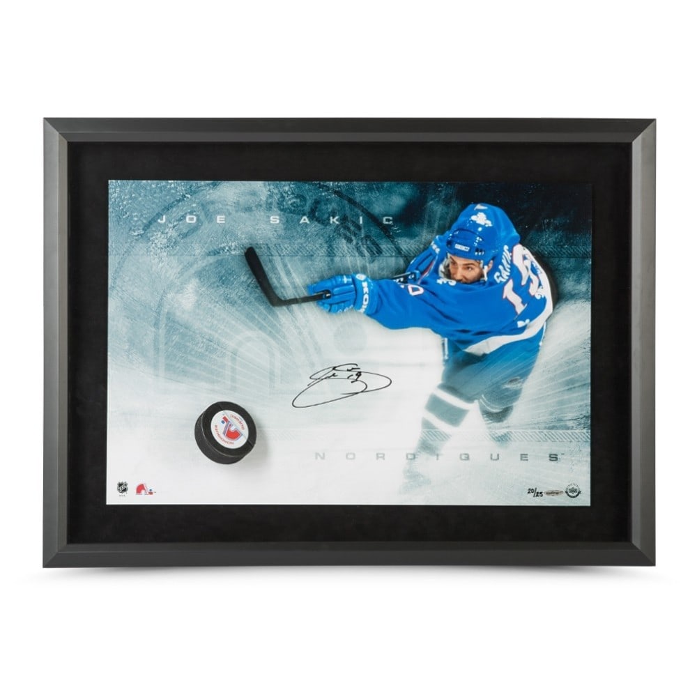 Joe Sakic Autographed Limited Edition 16x24 Break Thru Photo Nordiques #/25: Joe Sakic Autographed Limited Edition 16x24 Break Thru Photo Nordiques #/25 This exquisite Joe Sakic autographed 16X24 Break Thru photo captures the legendary moment of his slap shot while playing for