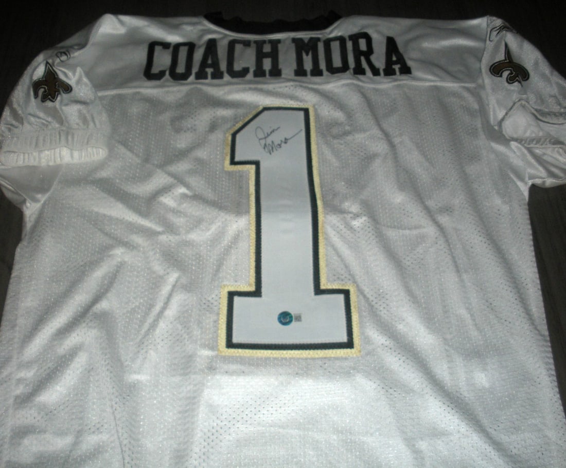 Jim Mora Signed New Orleans Saints Reebok Jersey with COA: Jim Mora Signed New Orleans Saints Reebok Jersey with COA This official licensed Reebok jersey, signed by Jim Mora, is a must-have for any New Orleans Saints fan. The jersey represents the spirit of N