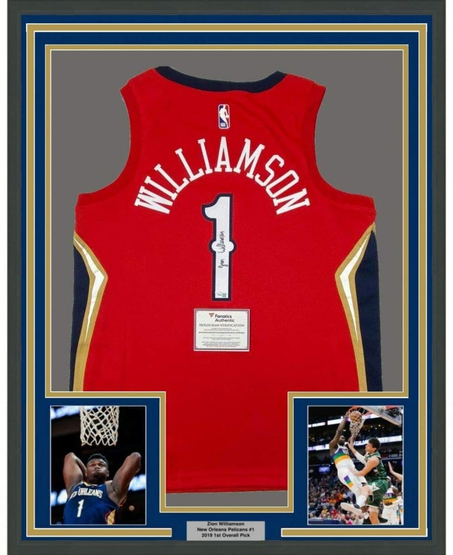 Framed Signed Zion Williamson Pelicans Red Jersey 33x42 with Fanatics COA: Framed Signed Zion Williamson Pelicans Red Jersey 33x42 with Fanatics COA Celebrate your passion for basketball with this framed autographed jersey of Zion Williamson, featuring the New Orleans Pelica