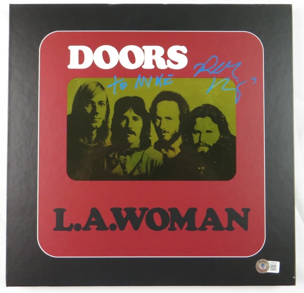 Robby Krieger Signed The Doors LA Woman Record CD Book Beckett Authenticated: Robby Krieger Signed The Doors LA Woman Record CD Book Beckett Authenticated This Robby Krieger autographed record CD book features the iconic album 'LA Woman' by The Doors. Included are the record an