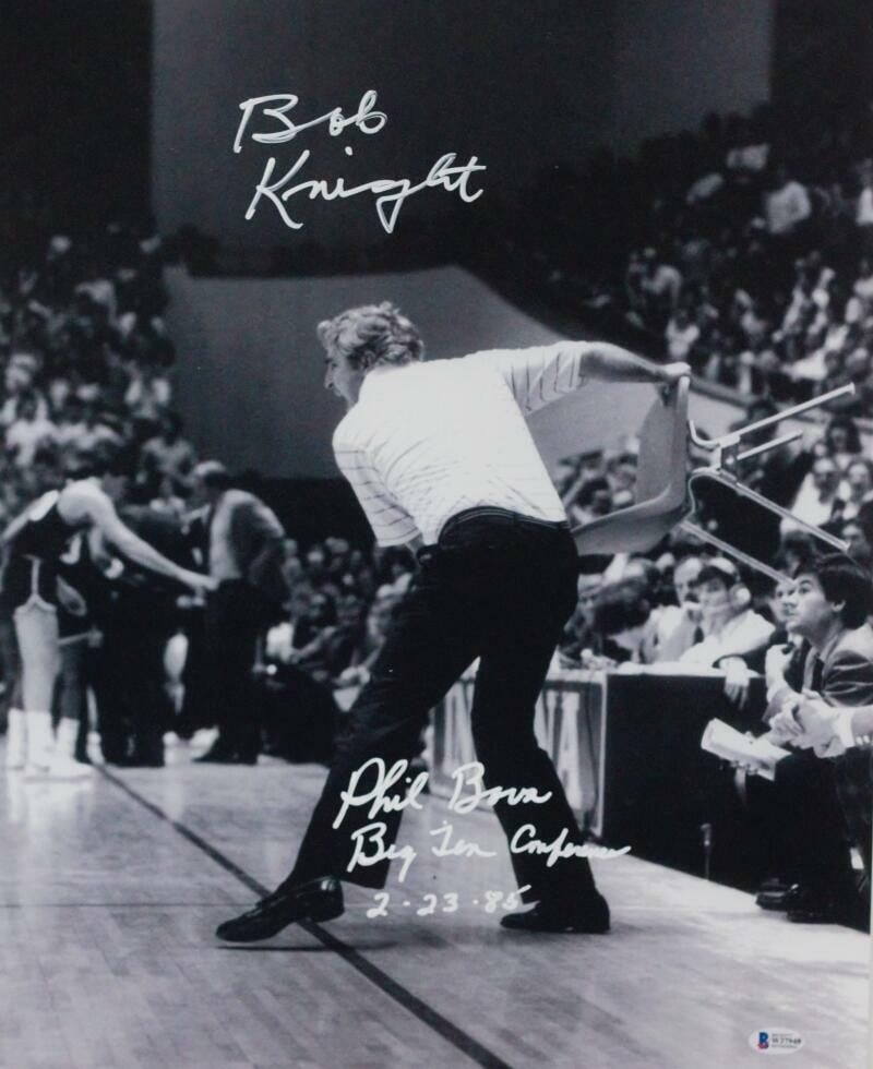 Bob Knight Phil Bova Signed 16x20 Photo with Inscription Beckett Authenticated: Bob Knight Phil Bova Signed 16x20 Photo with Inscription Beckett Authenticated This original 16x20 photo features Bob Knight and Phil Bova seated in a red chair, capturing a memorable moment. The phot