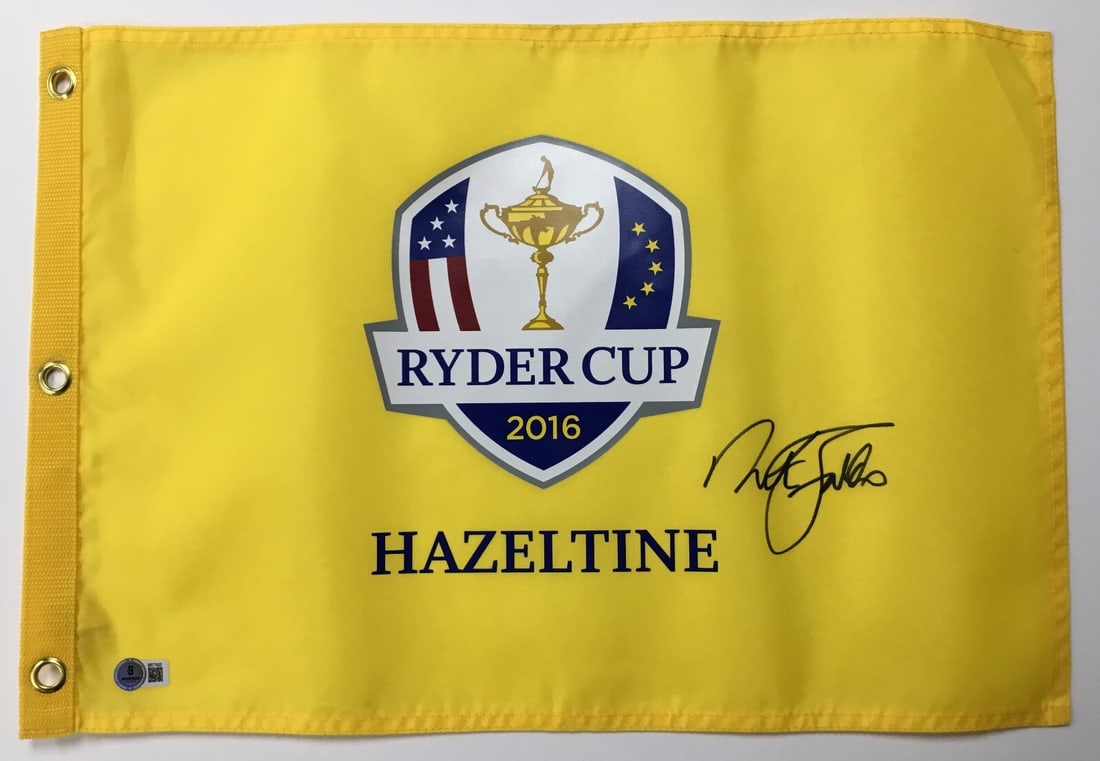 Nick Faldo Signed 2016 Ryder Cup Hazeltine Flag Beckett Authenticated: Nick Faldo Signed 2016 Ryder Cup Hazeltine Flag Beckett Authenticated This official 2016 Ryder Cup Hazeltine pin flag is signed by the legendary golfer Nick Faldo. The autograph has been authenticated
