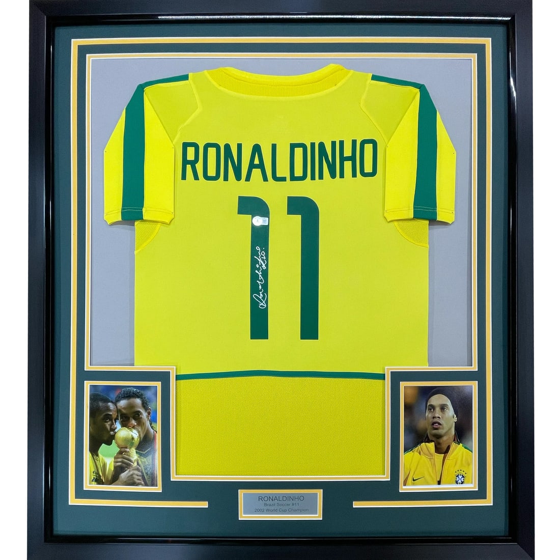 Framed Ronaldinho Signed Brazil Jersey 33x42 Beckett COA: Framed Ronaldinho Signed Brazil Jersey 33x42 Beckett COA This is a professionally framed and matted autographed Ronaldinho jersey, featuring the iconic yellow colors of the Brazil national team. Measu