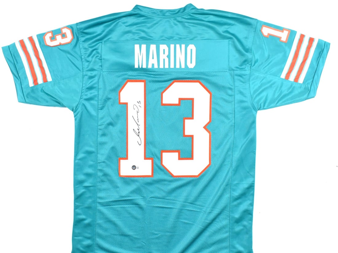 Dan Marino Miami Dolphins Autographed Teal Jersey Beckett Hologram: Dan Marino Miami Dolphins Autographed Teal Jersey Beckett Hologram This is an original teal pro style jersey autographed by legendary football player Dan Marino. The jersey features the iconic colors