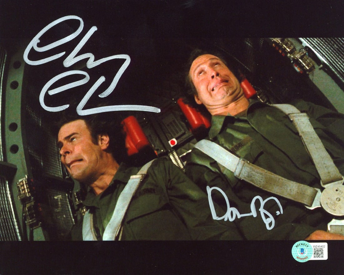 8x10 Photograph Signed by Chevy Chase and Dan Aykroyd Beckett Authenticated: 8x10 Photograph Signed by Chevy Chase and Dan Aykroyd Beckett Authenticated This 8x10 photograph from "Spies Like Us" features a G-Force Training scene and is personally signed by Chevy Chase and Dan