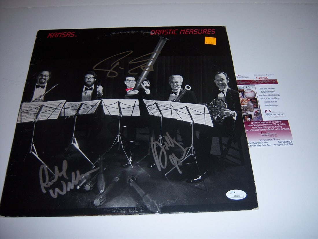 Kansas Drastic Measures Signed Album Rich Williams Phil Ehart JSA COA: Kansas Drastic Measures Signed Album Rich Williams Phil Ehart JSA COA This is an original signed record album of 'Drastic Measures' by Kansas, featuring signatures from Rich Williams, Phil Ehart, and