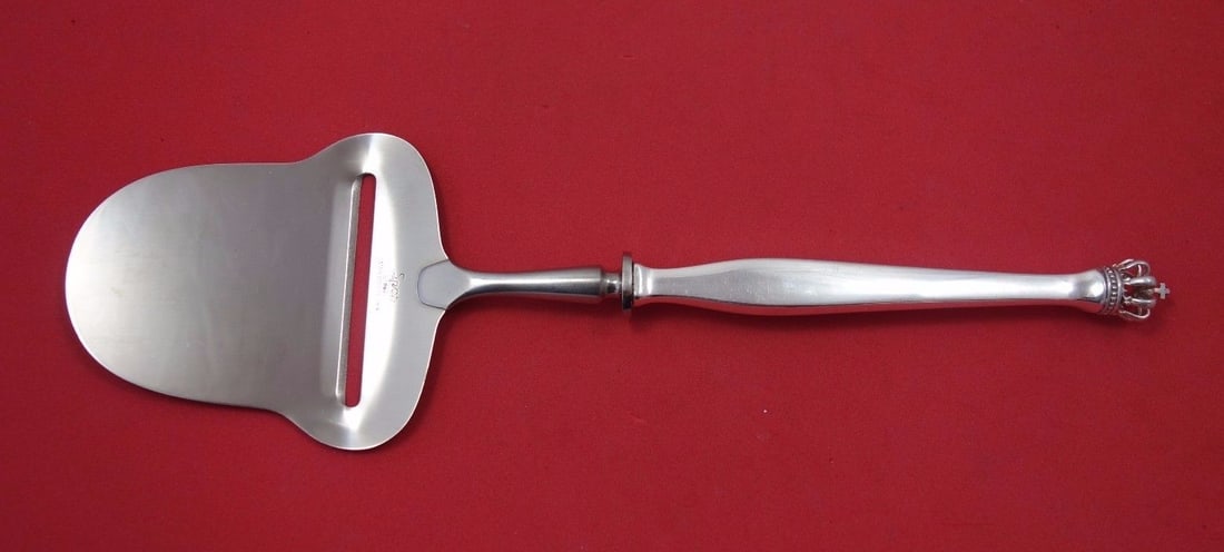 Dansk Guldmedes Crown Sterling Silver Cheese Plane 9 3/4": Dansk Guldmedes Crown Sterling Silver Cheese Plane 9 3/4" This elegant cheese plane features a hollow handle design, crafted from high-quality sterling silver. The piece is part of the Crown pattern b