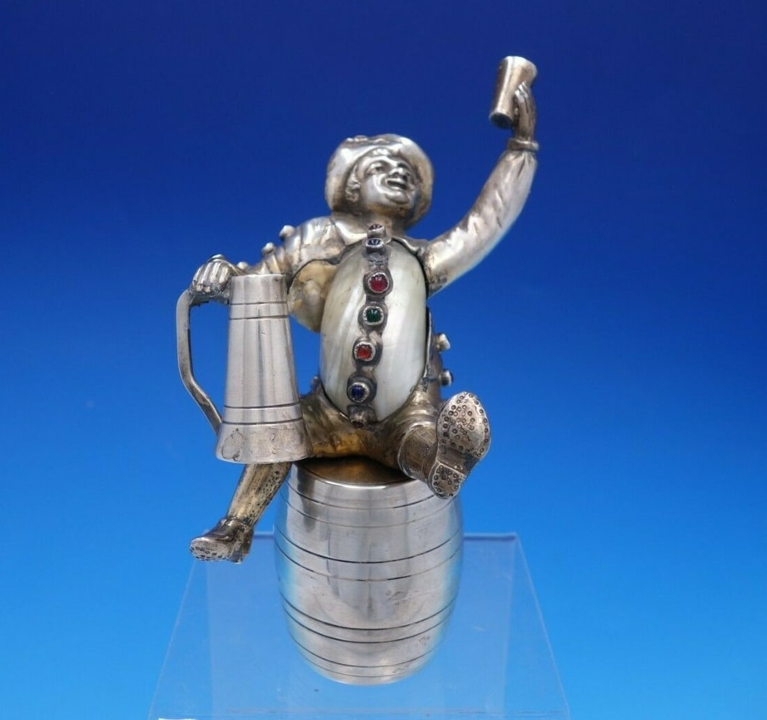 Vintage German Silver Plated Figurine Man on Barrel with Faux Gemstones: Vintage German Silver Plated Figurine Man on Barrel with Faux Gemstones This charming German figurine showcases a silver plate man sitting atop a barrel, cheerfully holding a mug or stein. His unique