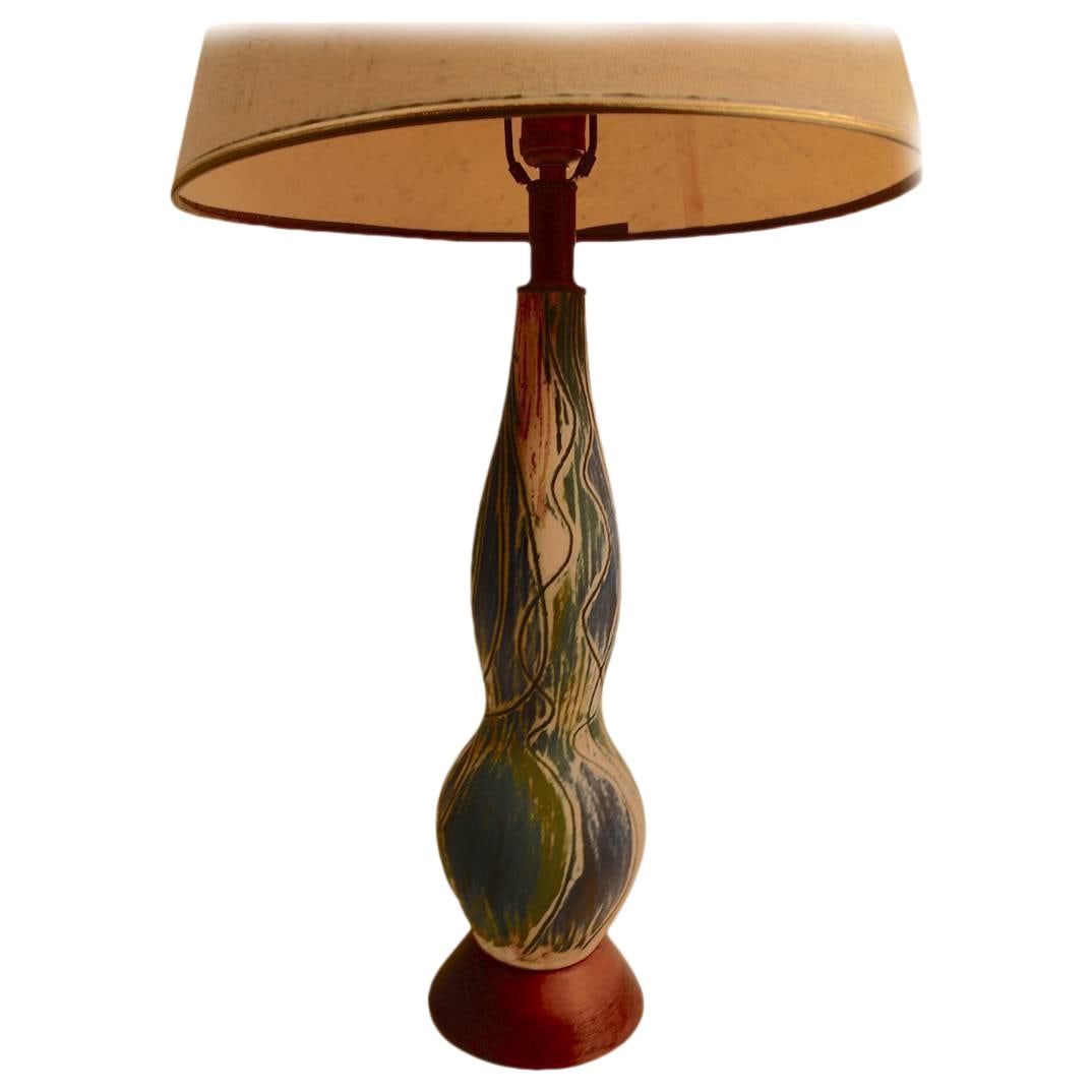 Mid Century Green Pottery Lamp with Walnut Base Sgraffito Design: Mid Century Green Pottery Lamp with Walnut Base Sgraffito Design This striking Mid Century Art Pottery Lamp features a beautifully crafted matte glaze with intricate sgraffito decoration, showcasing a
