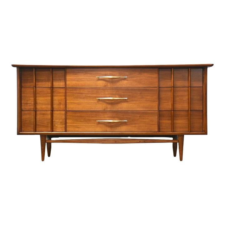 Mid Century Walnut Kent Coffey Foreteller Dresser with Brass Pulls: Mid Century Walnut Kent Coffey Foreteller Dresser with Brass Pulls This mid-century modern dresser is a stunning example of craftsmanship, featuring a rich walnut finish and nine spacious drawers, per