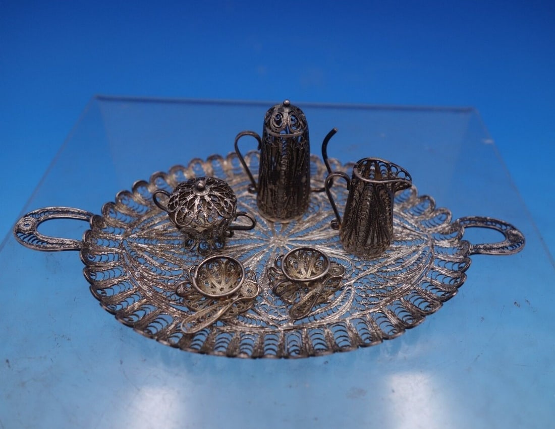 Charming Sterling Silver Filigree Miniature Tea Set 6pc: Charming Sterling Silver Filigree Miniature Tea Set 6pc This exquisite six-piece miniature tea set features a charming filigree design and is crafted from sterling silver. Perfect for dollhouses, the