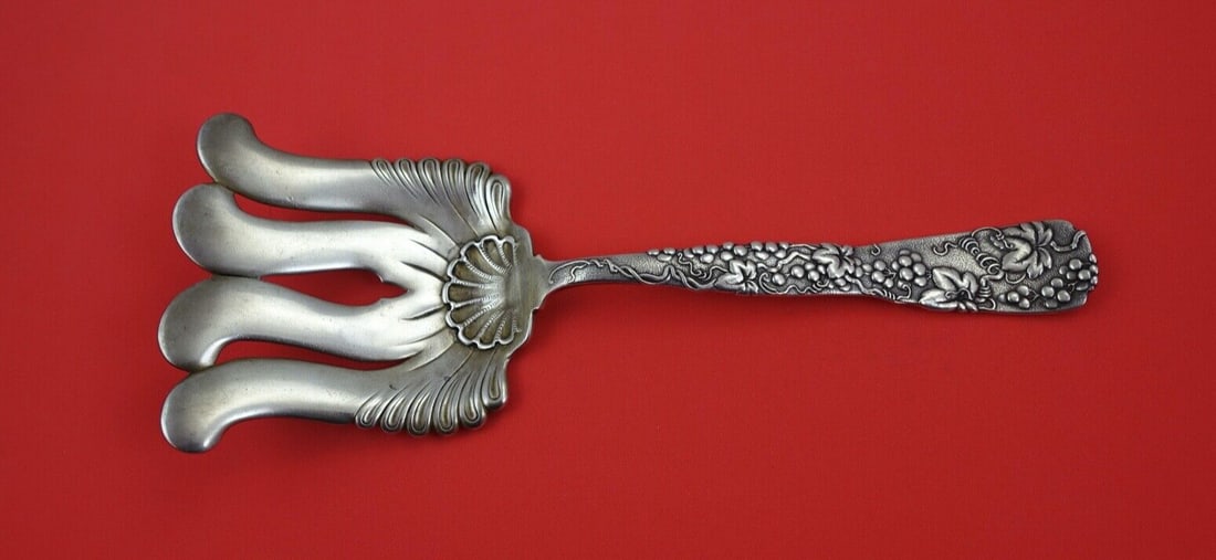 Tiffany & Co. Vine Sterling Silver Asparagus Fork 9.75" Grape Motif: Tiffany & Co. Vine Sterling Silver Asparagus Fork 9.75" Grape Motif This exquisite asparagus serving fork, crafted by Tiffany & Co., showcases the elegant Vine pattern, a hallmark of Tiffany's sterlin