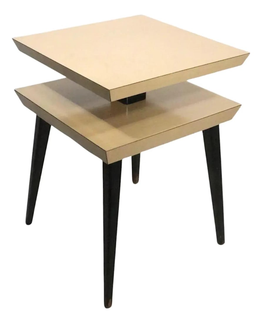 Blonde Formica Laminate Two Level End Table with Solid Wood Legs: Blonde Formica Laminate Two Level End Table with Solid Wood Legs This mid-century two-tier side or end table features a classic design with a faux wood grain blonde formica laminate top, supported by