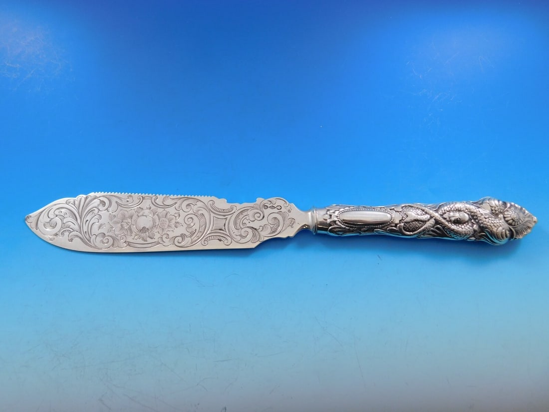 Albert Coles Sterling Silver Dolphin Ice Cream Slice 11 3/4 Inch Monogrammed: Albert Coles Sterling Silver Dolphin Ice Cream Slice 11 3/4 Inch Monogrammed This exquisite ice cream slice from Albert Coles features a serrated blade adorned with an intricately engraved fruit desig