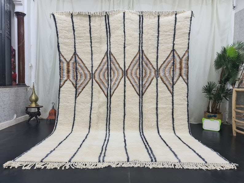 Handmade White Moroccan Berber Wool Rug 9.84 x 6.56 Feet: Handmade White Moroccan Berber Wool Rug 9.84 x 6.56 Feet Enhance your living space with this authentic, stylish, and soft handmade Moroccan Berber wool rug. The stunning white design adds a touch of e