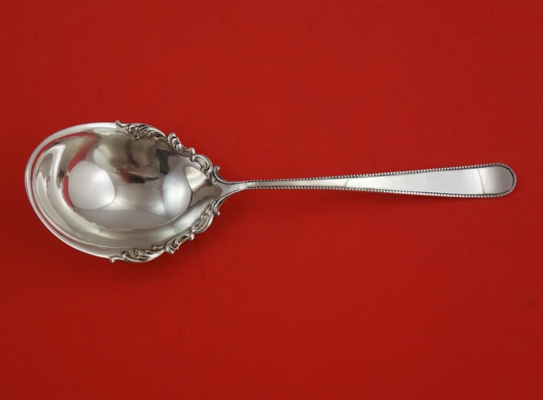 Shreve & Co Beaded Sterling Silver Berry Spoon 9 1/4": Shreve & Co Beaded Sterling Silver Berry Spoon 9 1/4" This exquisite serving spoon, designed in the Beaded pattern by Shreve & Co., is crafted from high-quality sterling silver. Measuring 9 1/4" in le