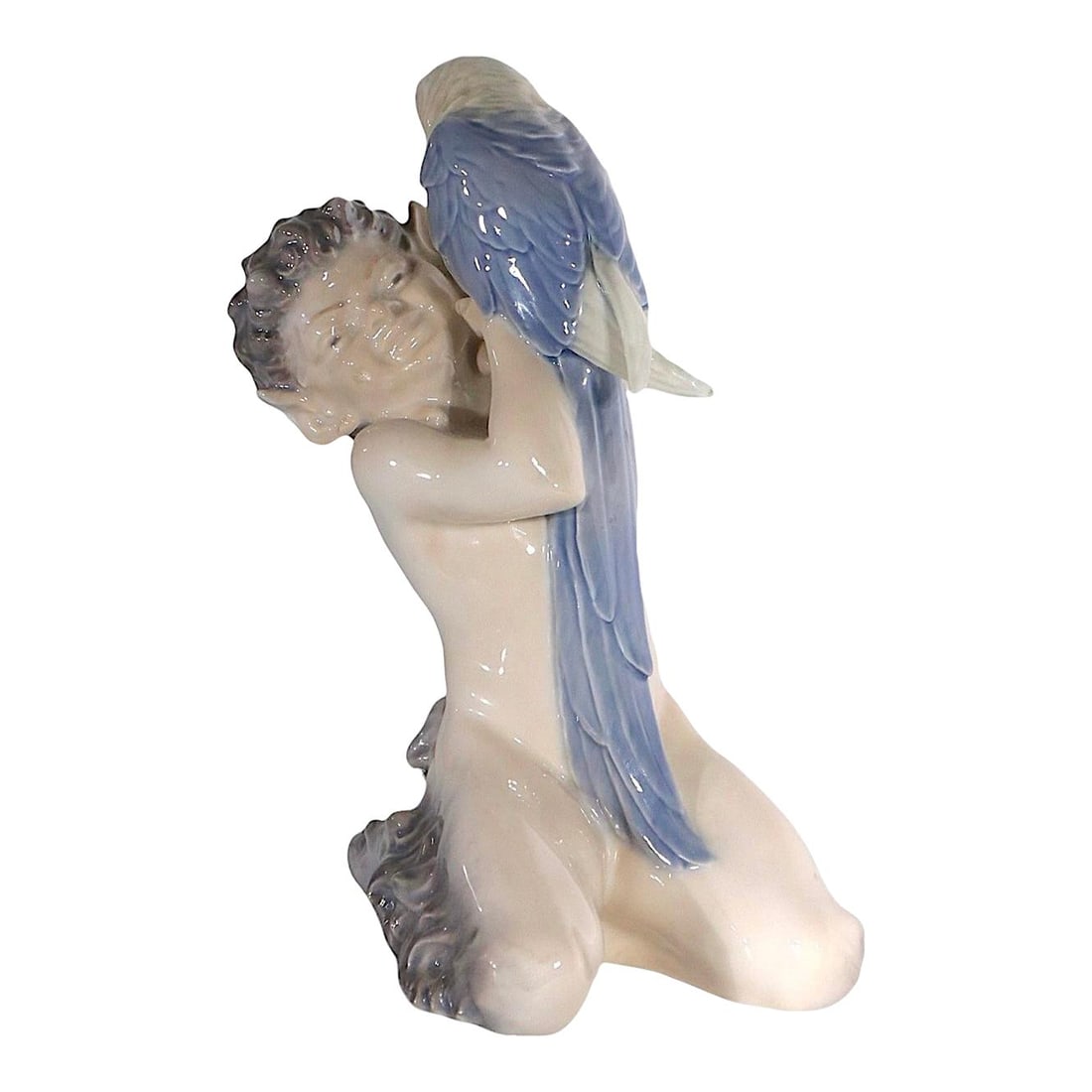 Royal Copenhagen Faun and Parrot Figurine by Christian Thomsen 1950s Model 752: Royal Copenhagen Faun and Parrot Figurine by Christian Thomsen 1950s Model 752 This exquisite porcelain figurine features a Faun, or Pan, gracefully accompanied by a parrot. Crafted in Denmark during