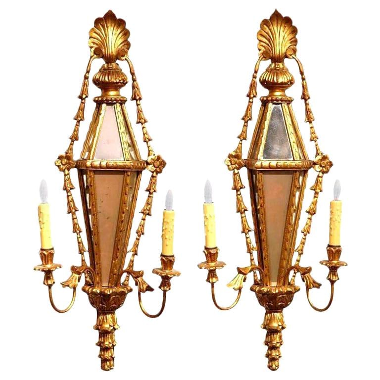 Elegant Pair of 19th Century Louis XVI Giltwood Mirrored Sconces: Elegant Pair of 19th Century Louis XVI Giltwood Mirrored Sconces Enhance your home with this exquisite pair of 19th Century French Louis XVI Carved Giltwood and Mirrored Wall Sconces. Crafted in Franc