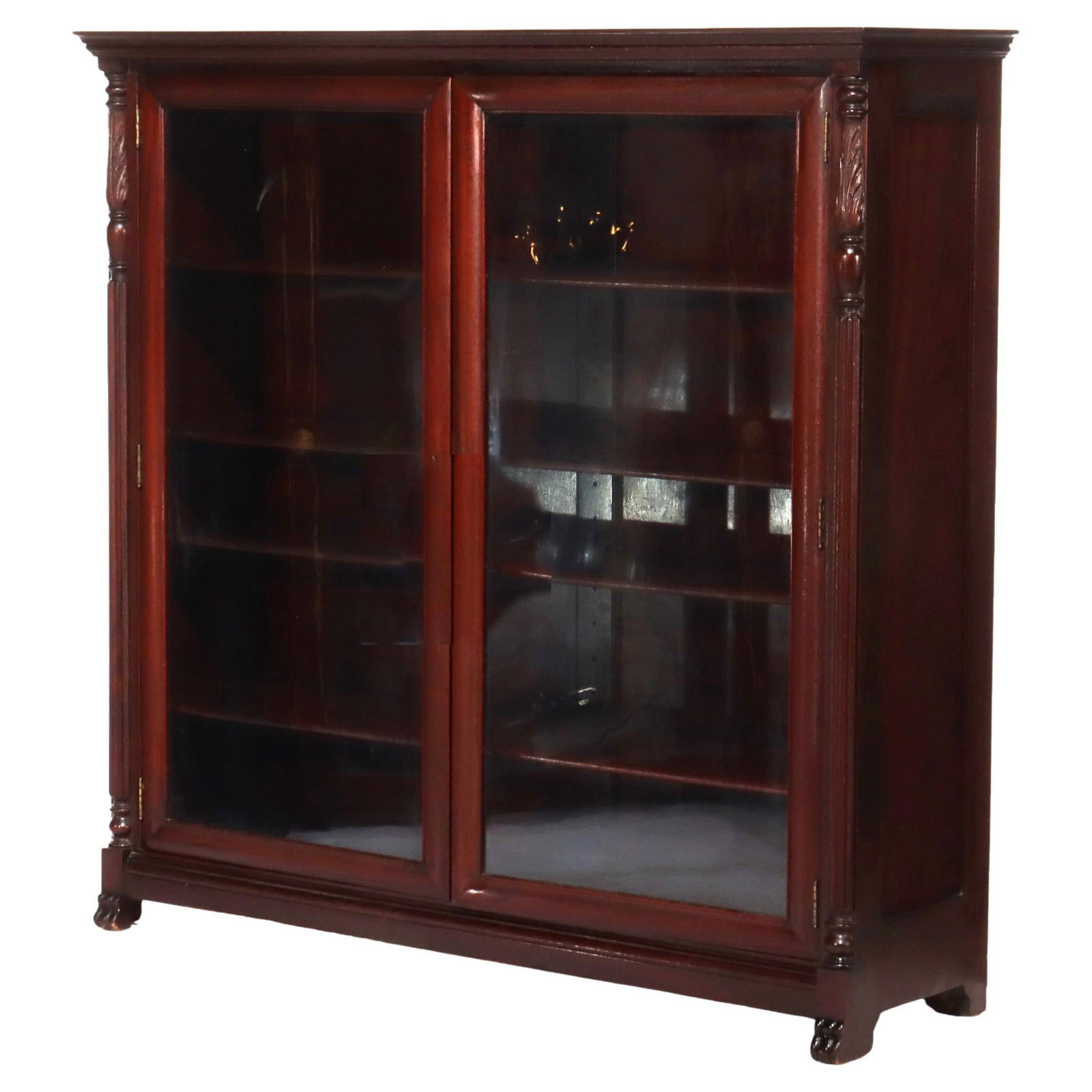 Early 20thC Antique American Empire Mahogany Double Door Bookcase: Early 20thC Antique American Empire Mahogany Double Door Bookcase This Antique American Empire Carved Mahogany Double Door Bookcase is a beautiful representation of early 20th-century design. Crafted