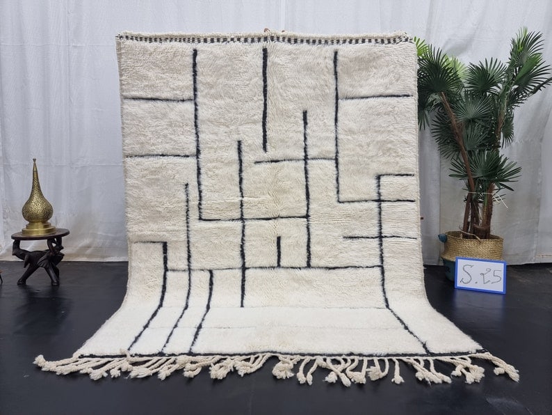 Handwoven Moroccan Berber Wool Rug with Engraved Pattern 8 x 5 Feet: Handwoven Moroccan Berber Wool Rug with Engraved Pattern 8 x 5 Feet Transform your space with this stunning soft white Moroccan Berber wool rug, featuring a unique black engraved pattern. Handwoven by