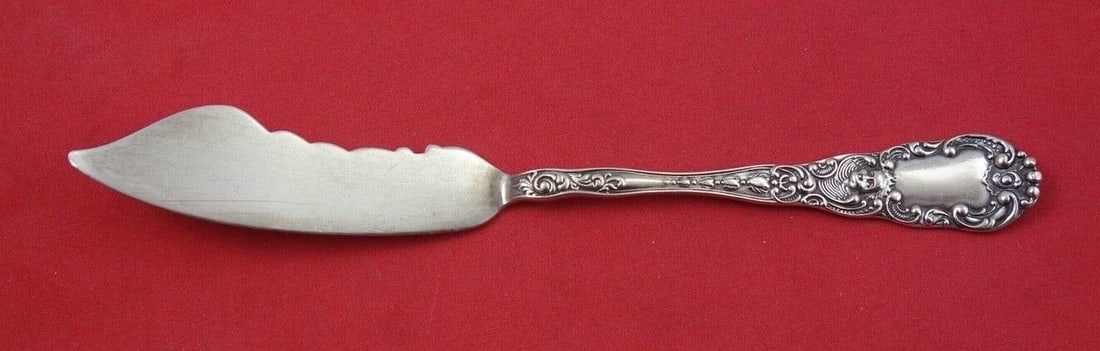 Dominick & Haff Cupid Sterling Silver 7" Master Butter Knife: Dominick & Haff Cupid Sterling Silver 7" Master Butter Knife Presenting the exquisite "Cupid" Master Butter Knife by Dominick and Haff, crafted in sterling silver. This elegant piece features a flat h