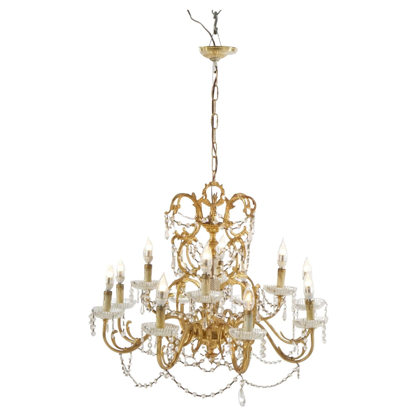 Vintage French Gilt Crystal Twelve-Light Chandelier Circa 1930: Vintage French Gilt Crystal Twelve-Light Chandelier Circa 1930 This exquisite French Style Gilt and Crystal Twelve-Light Tiered Chandelier, dating back to circa 1930, showcases a stunning gilt frame a