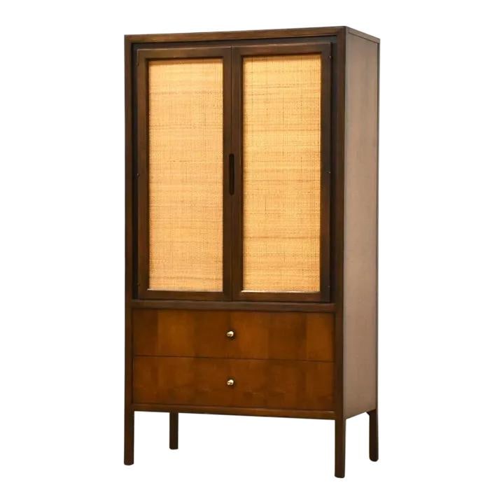 1960s Mid Century Modern Walnut Cane Armoire Dresser with Brass Knobs: 1960s Mid Century Modern Walnut Cane Armoire Dresser with Brass Knobs This stunning 1960s mid-century modern armoire dresser features a rich walnut finish complemented by elegant cane accents. Designe