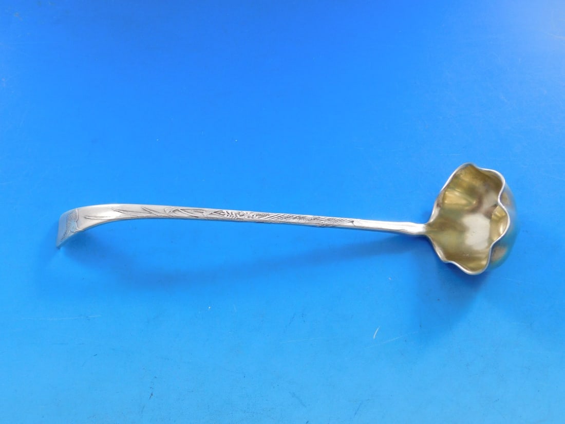 Tiffany & Co. Lap Over Edge Sterling Silver Sauce Ladle 6 3/4" Bird Grass Motif: Tiffany & Co. Lap Over Edge Sterling Silver Sauce Ladle 6 3/4" Bird Grass Motif This exquisite sauce ladle from Tiffany & Co. features the elegant Lap Over Edge pattern, crafted in sterling silver. Th