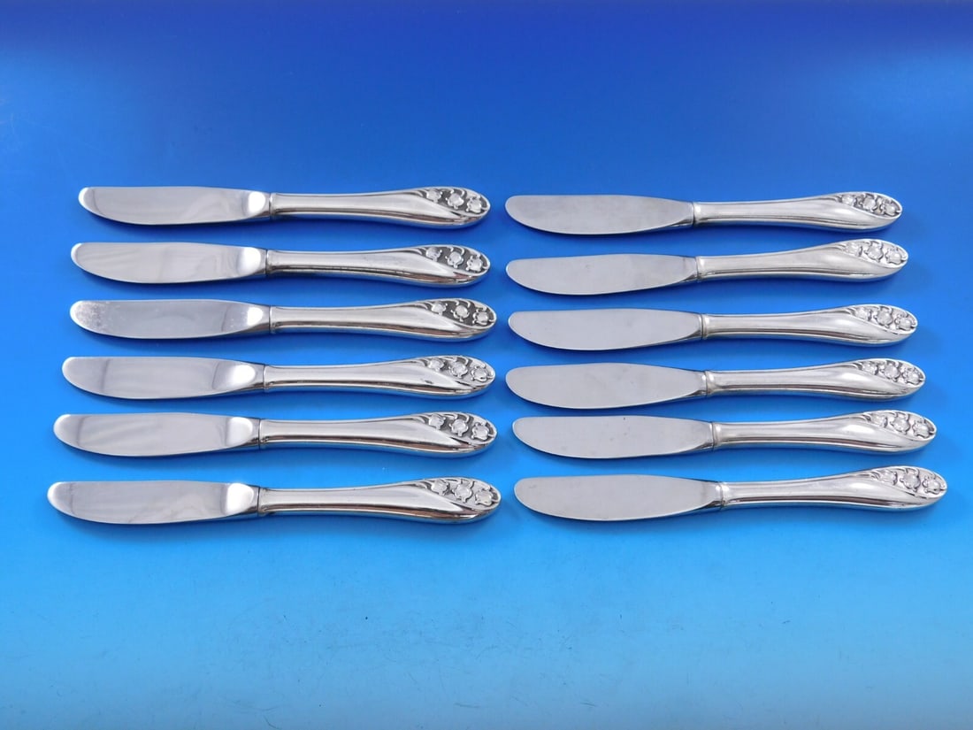 Gorham Lily of the Valley Sterling Silver Butter Spreader Set 12 pcs: Gorham Lily of the Valley Sterling Silver Butter Spreader Set 12 pcs Enhance your dining experience with this exquisite set of 12 butter spreaders from Gorham, featuring the elegant Lily of the Valley